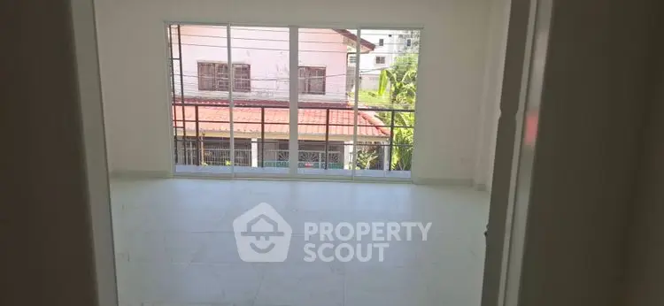 Spacious empty room with large windows and natural light