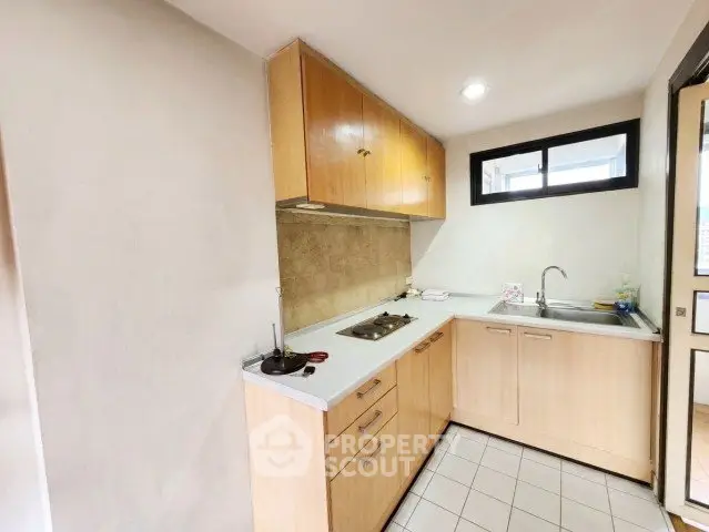 Cozy kitchen with closed layout and modern appliances in a bright apartment.