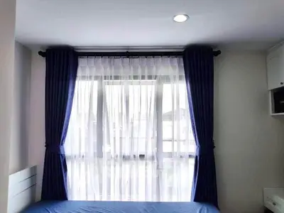Cozy bedroom with elegant blue curtains and natural light