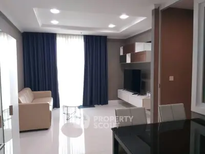 Modern living room with sleek furniture and large window for natural light.