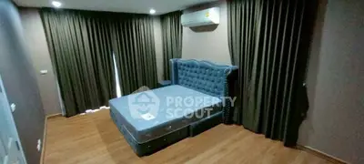 Spacious bedroom with elegant bed and air conditioning, featuring floor-to-ceiling curtains for privacy.