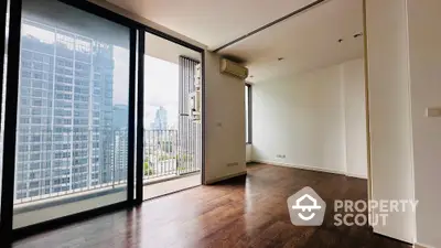 Spacious modern apartment with balcony and city view, featuring sleek wooden flooring and large windows.