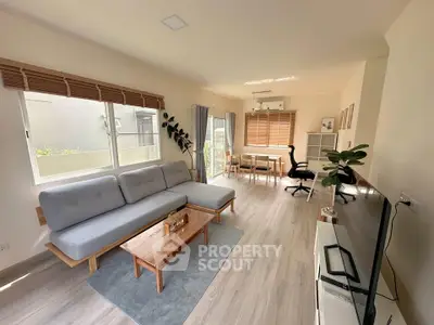 Spacious modern living room with natural light and stylish furniture
