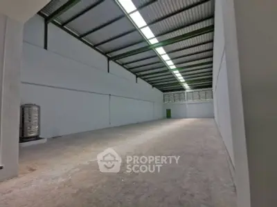 Spacious industrial warehouse with high ceilings and ample storage space.
