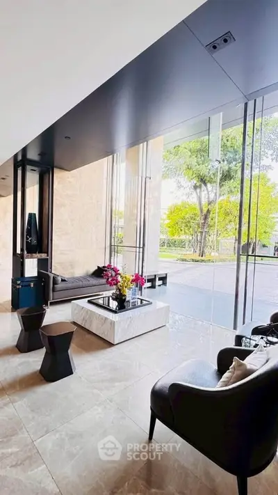 Luxurious modern living room with floor-to-ceiling windows and elegant furnishings.