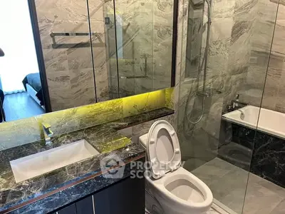 Luxurious modern bathroom with marble finishes and glass shower enclosure