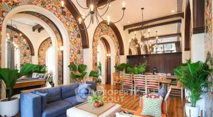 Luxurious living room with vibrant decor and elegant chandeliers