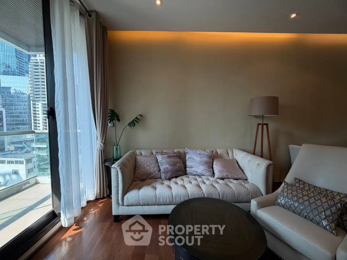 Luxurious living room with elegant sofa and city view balcony, perfect for urban living.