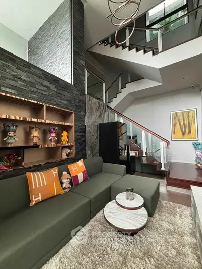 Modern living room with stylish staircase and cozy seating area