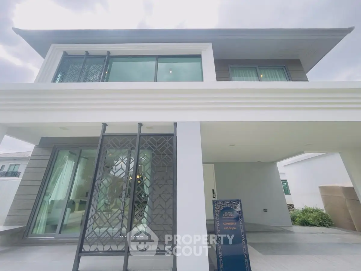 Modern two-story house with large windows and stylish facade