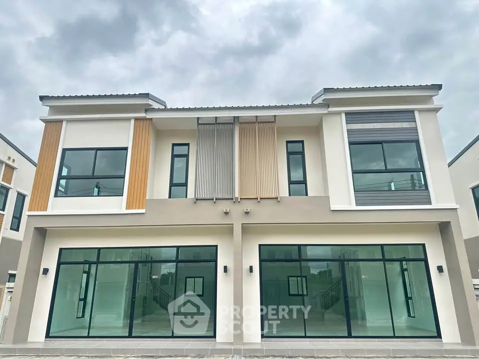 Modern duplex with large windows and contemporary design, perfect for family living.