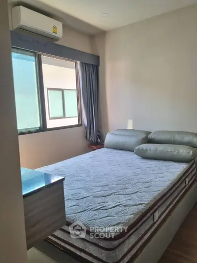 Cozy bedroom with natural light and modern air conditioning unit