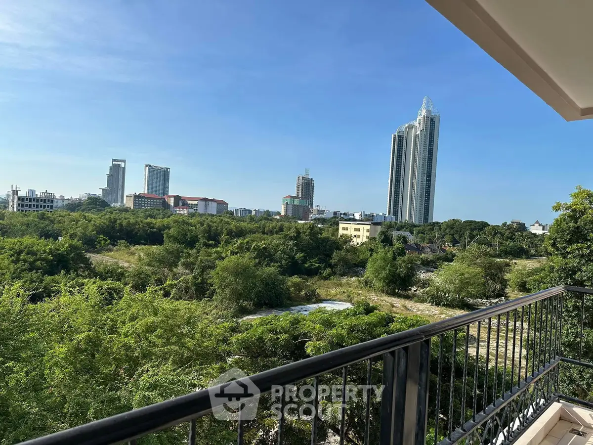 Stunning cityscape view from a spacious balcony with lush greenery and modern skyscrapers.