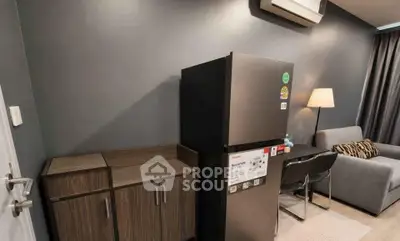 Modern apartment interior with sleek fridge, stylish furniture, and ambient lighting.