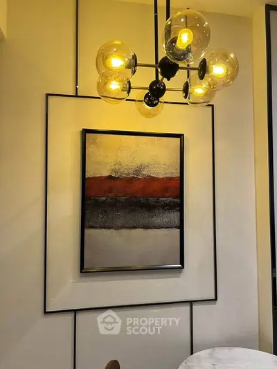 Modern interior with stylish lighting and abstract art in a cozy living space.
