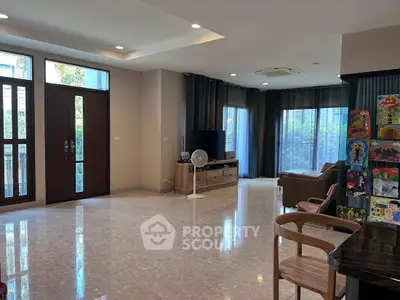 Spacious living room with modern decor and large windows for natural light