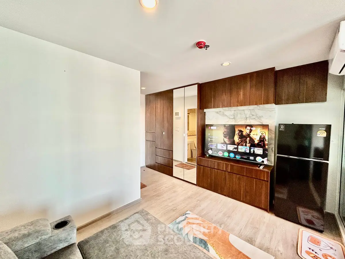 Modern living room with sleek TV setup and stylish wooden cabinetry