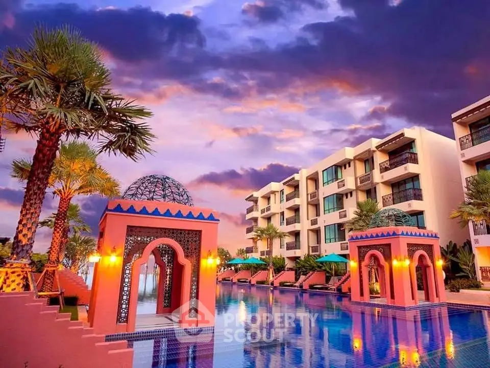 Luxurious resort-style pool with stunning architecture and vibrant sunset sky