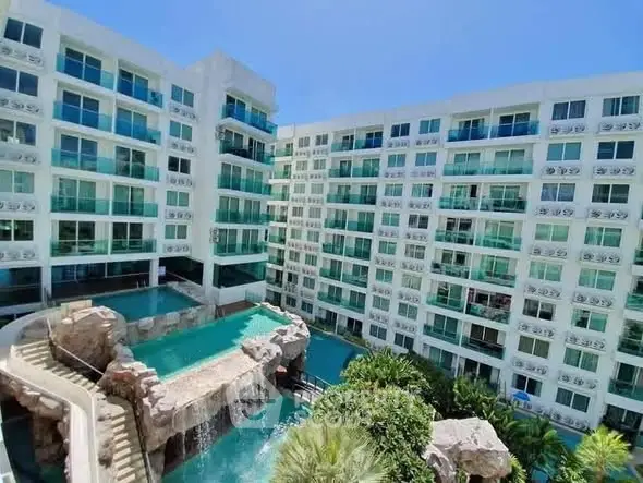 Luxurious condominium with stunning pool and waterfall feature, perfect for modern living.