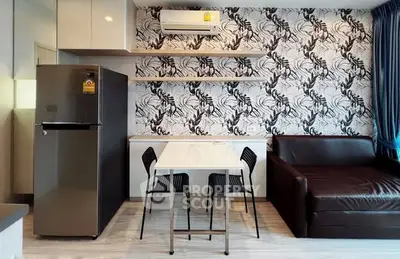 Modern living room with stylish wallpaper, sleek furniture, and compact dining area in a contemporary apartment.
