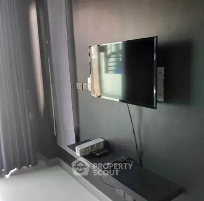Modern living room with wall-mounted TV and sleek decor