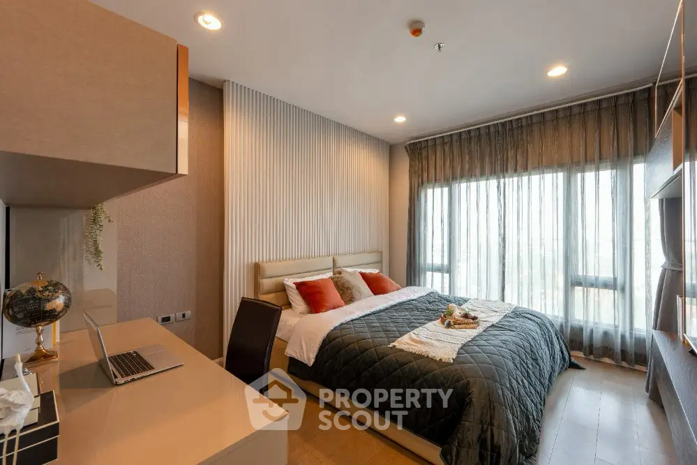 Luxurious modern bedroom with large window and elegant decor in high-end apartment.