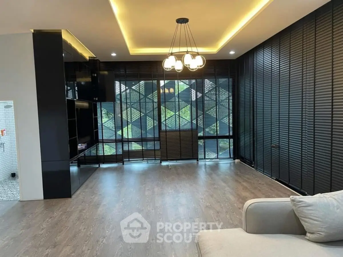 Spacious modern living room with large windows and stylish lighting