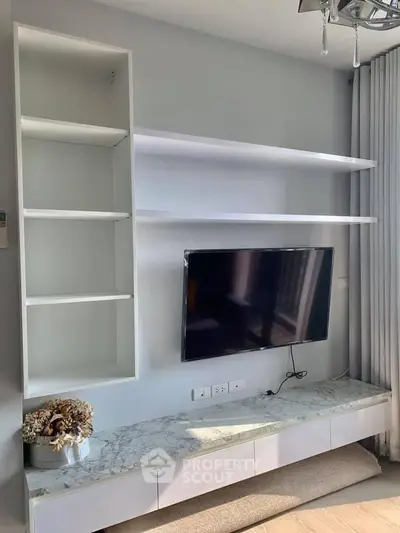Modern living room with wall-mounted TV and sleek shelving unit