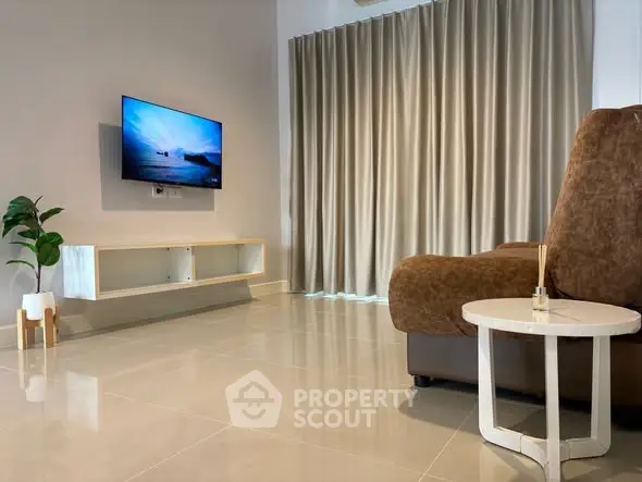 Modern living room with sleek TV setup and cozy seating area