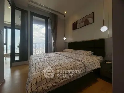 Modern bedroom with large windows and city view, featuring stylish decor and ample natural light.