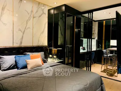 Luxurious modern bedroom with elegant marble accents and stylish furnishings in a high-end apartment.