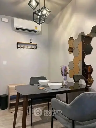 Modern dining area with stylish hexagonal wall decor and sleek furniture