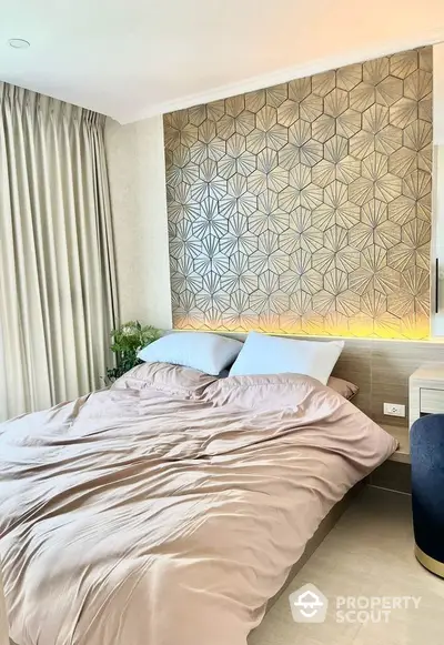 Luxurious bedroom with stylish geometric accent wall and soft lighting