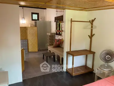 Charming open-plan living space with modern decor and cozy seating area.