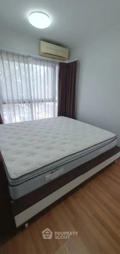 Modern bedroom with large window and stylish decor