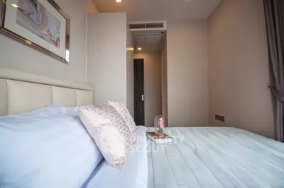 Cozy bedroom with elegant decor and soft lighting, perfect for relaxation and comfort.