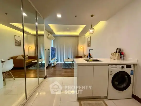 Modern open-plan living room with washing machine and stylish decor