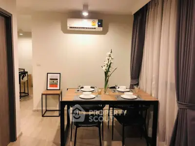 Modern dining area with elegant table setting and air conditioning in a cozy apartment.
