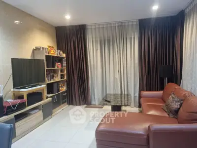 Modern living room with leather sofa and entertainment center