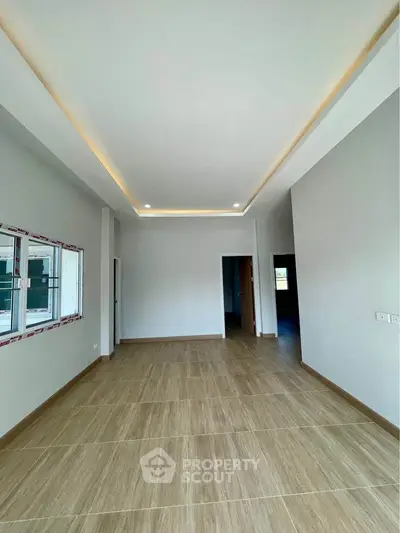 Spacious modern living room with elegant ceiling lights and large windows