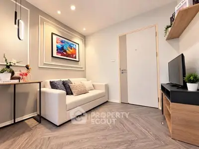 Modern living room with stylish decor and cozy ambiance, featuring a sleek sofa and contemporary artwork.