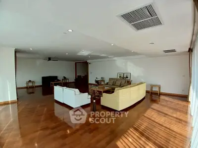 Spacious living room with elegant wooden flooring and modern furniture