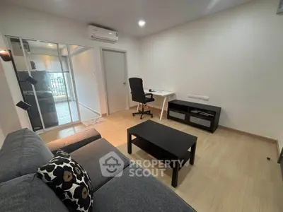 Modern living room with sleek furniture and natural light, perfect for relaxation and productivity.