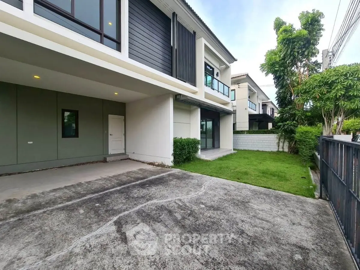 Modern two-story house with spacious driveway and lush green lawn