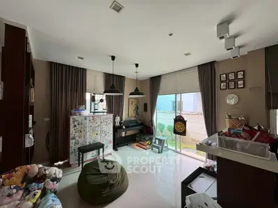 Spacious living room with modern decor and large windows offering natural light.