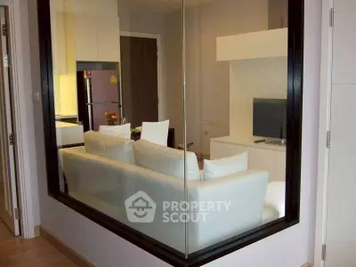 Modern living room with white sofa and sleek TV unit in stylish apartment.