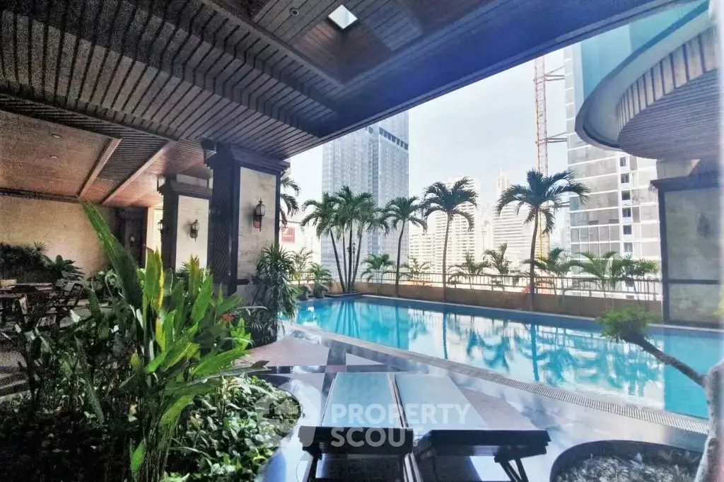 Luxurious rooftop pool with stunning city views and lush greenery