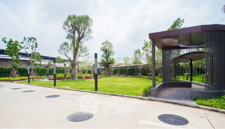 Modern residential garden with lush greenery and stylish gazebo, perfect for relaxation and outdoor activities.