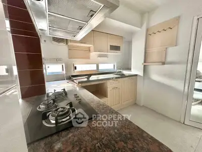 Modern kitchen with gas stove and sleek cabinetry in a bright, open layout.