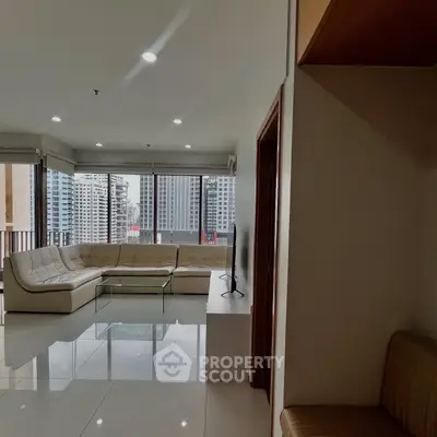 Spacious living room with city view and modern furnishings